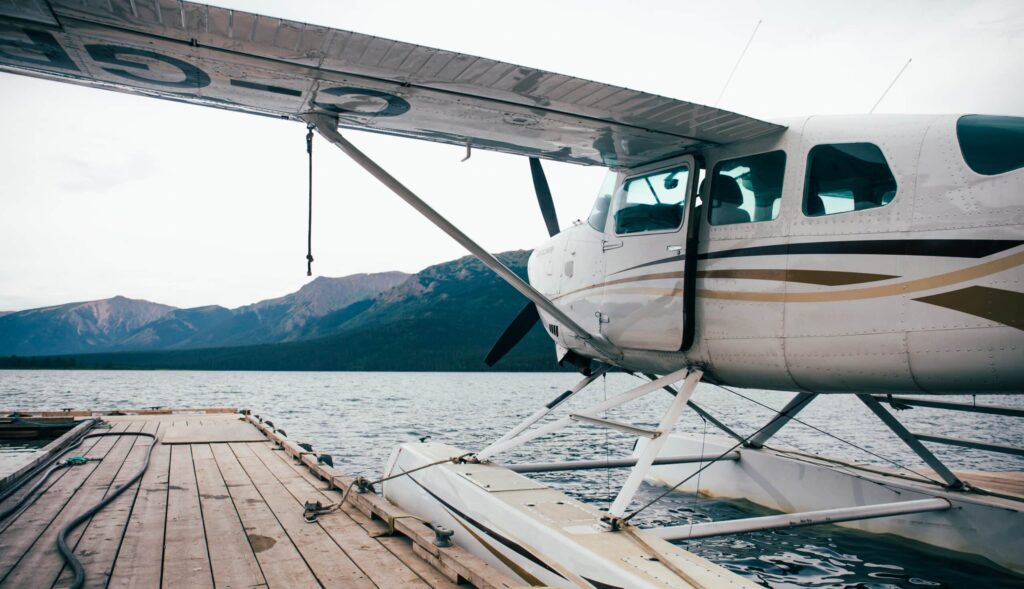 Float,Plane,Attached,To,A,Dock.,Cloudy,Day.,Mountains,In
