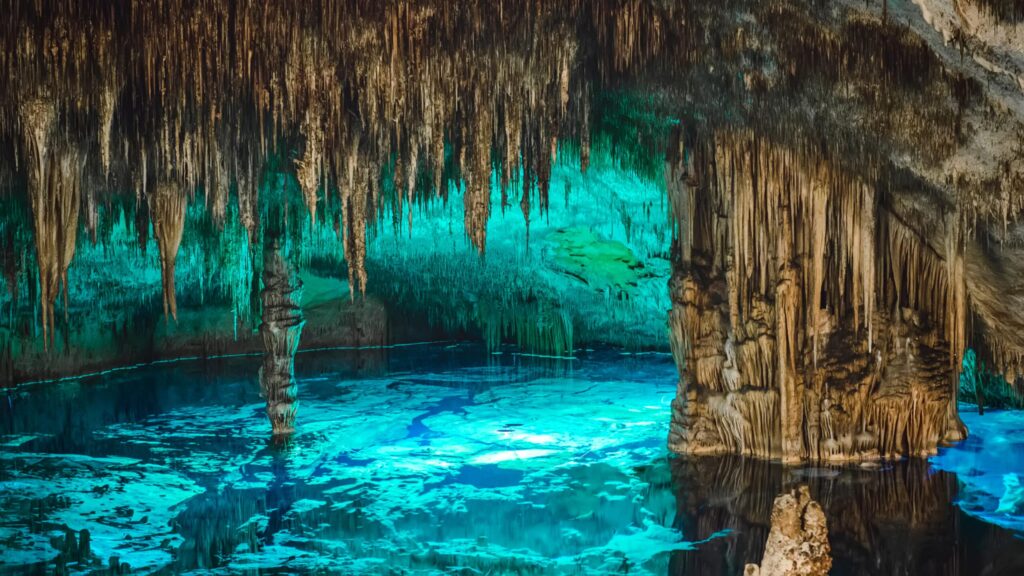 Lighted,Cave,With,Blue,Water,And,Turquoise,In,Mallorca.