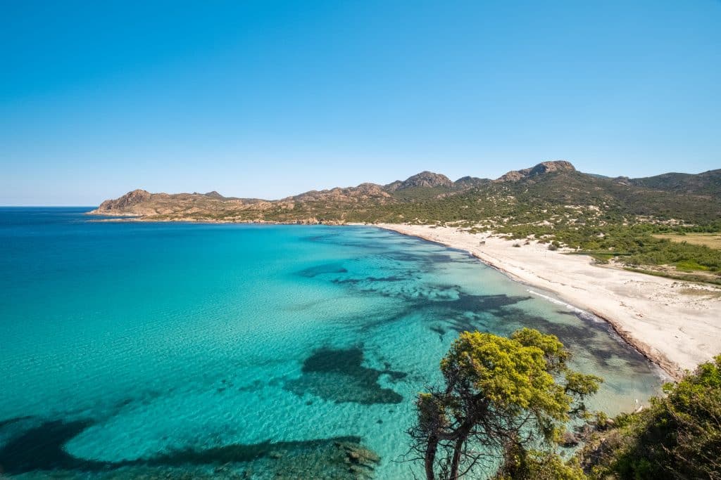 Translucent,Turquoise,Mediterranean,Sea,Lapping,Onto,An,Almost,Deserted,Ostriconi