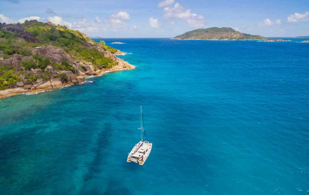Aerial,View,Of,Catamaran,Sailing,In,Coastline.,Tropical,Seychelles,Island