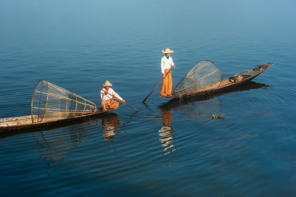 Burmese,Fisherman,On,Bamboo,Boat,Catching,Fish,In,Traditional,Way