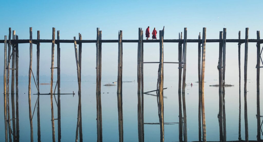 Buddhist,Monks,Crossing,U,Bein,Bridge,At,Sunrise,In,Amarapura,