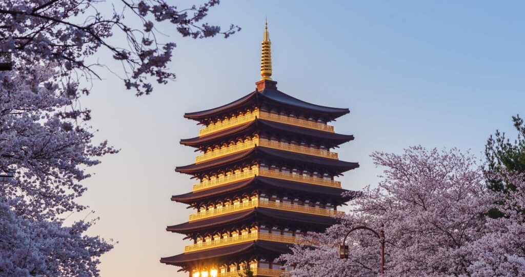 Hwangnyongsa,Nine story,Wooden,Pagoda,And,Reflective,Sunlight,With,Cherry,Blossoms