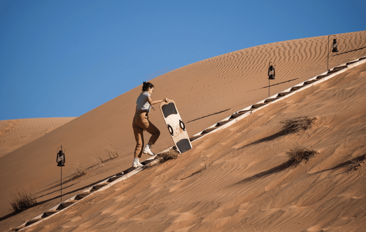 Camp privé désert Oman snowboard