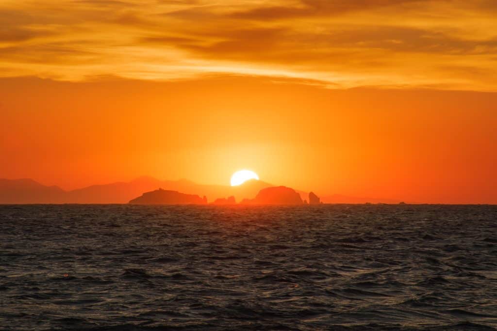 Watching,A,Golden,Sunset,With,The,Sun,Hiding,Behind,Far