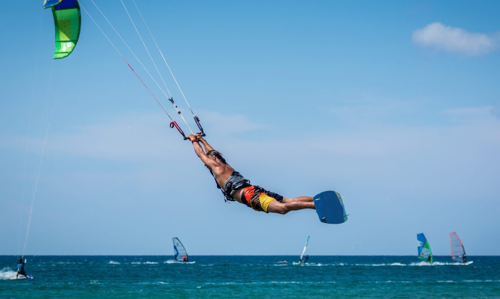Man,Kitesurfer,Athlete,Jumping,While,Performing,Kite surfing
