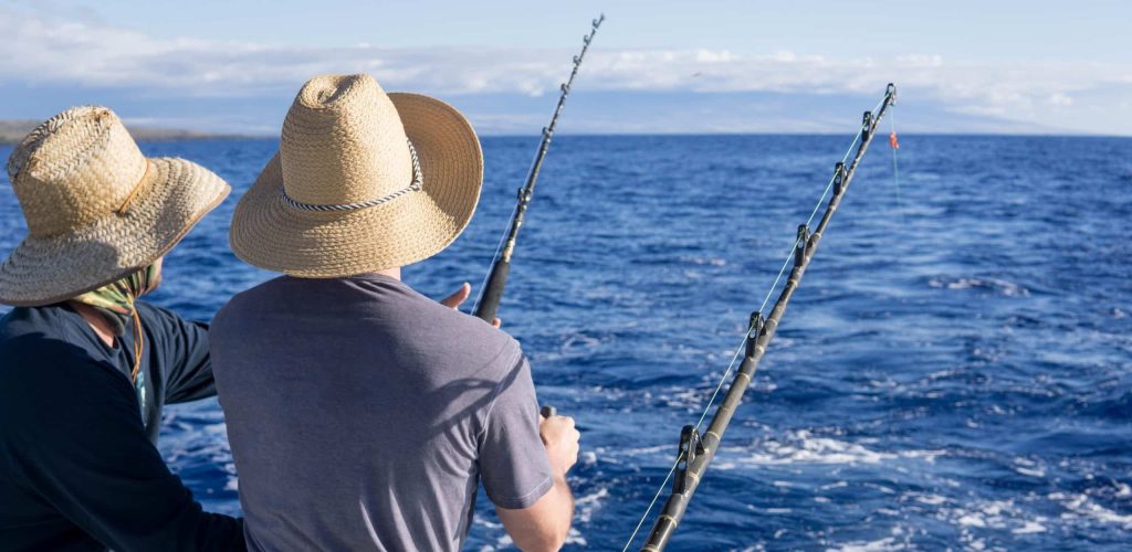 Two,Men,Fishing,On,A,Boat.,Fishing,Trip,While,On